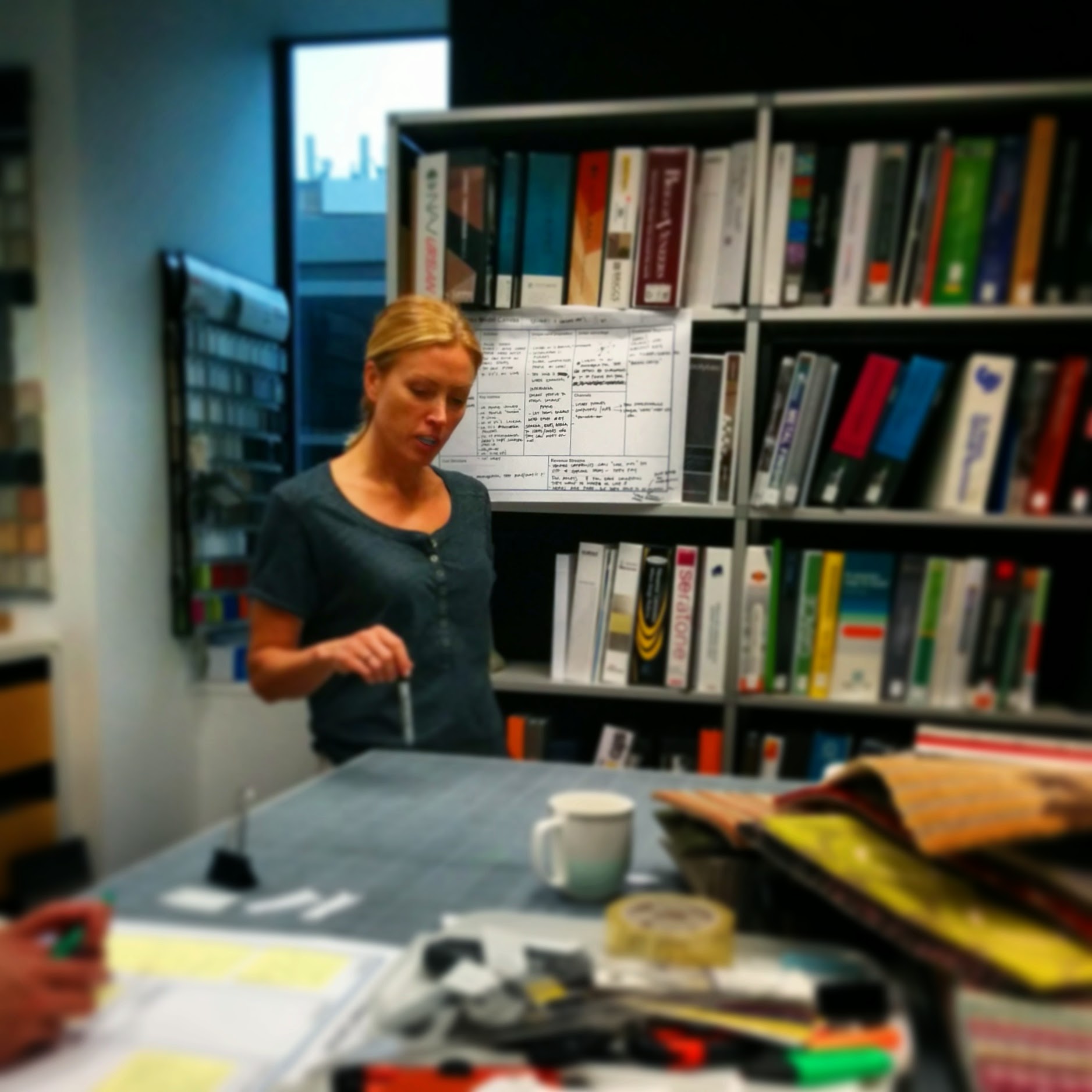 Ninotschka Titchkosky with a lean canvas pinned up behind her