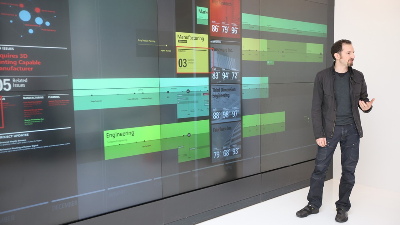 A picture of Anton Andrews standing in front of a large display.